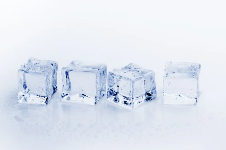 Fresh ice cubes on a wet surface, representing the benefits of cold water exposure for invigoration and health